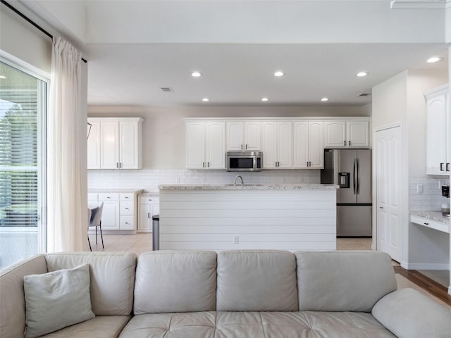 living room featuring recessed lighting and light tile patterned floors