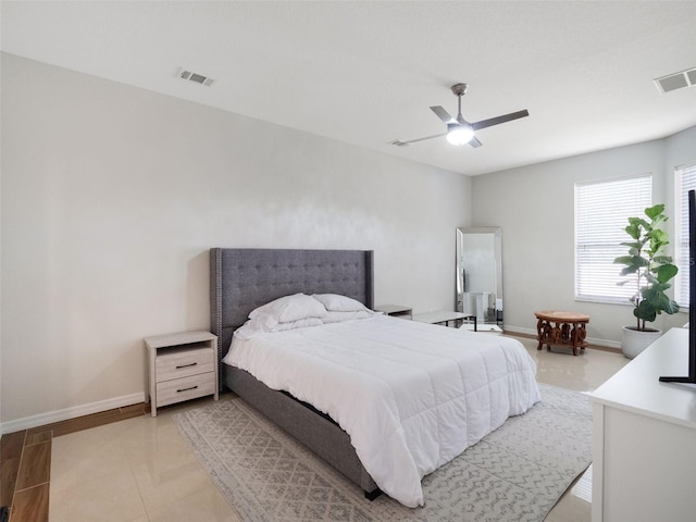 bedroom featuring baseboards, a ceiling fan, and visible vents