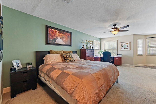 14037 Fairway Willow Ln, Winter Garden, FL 34787 - bedroom featuring light colored carpet, a textured ceiling, an office area, and a ceiling fan