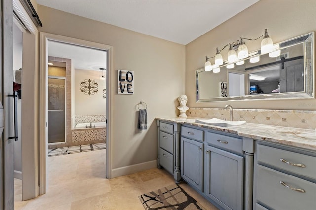 14037 Fairway Willow Ln, Winter Garden, FL 34787 - full bath with vanity, tile patterned flooring, tiled tub, tiled shower, and backsplash