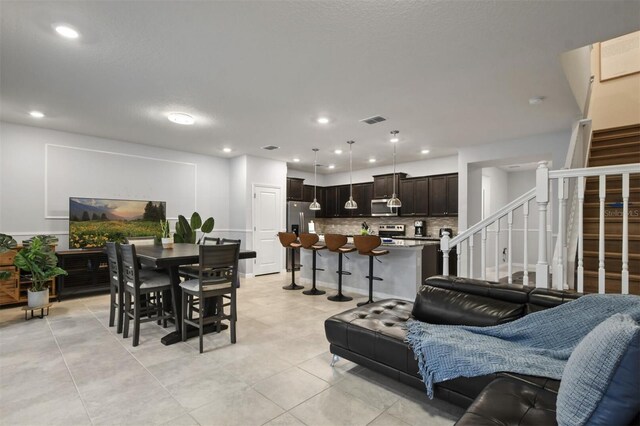 3806 Lana Ave, Davenport, FL 33897 - living room featuring stairs, recessed lighting, and light tile patterned floors