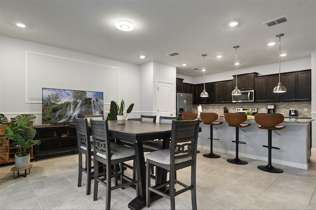 3806 Lana Ave, Davenport, FL 33897 - dining area featuring light tile patterned flooring and recessed lighting