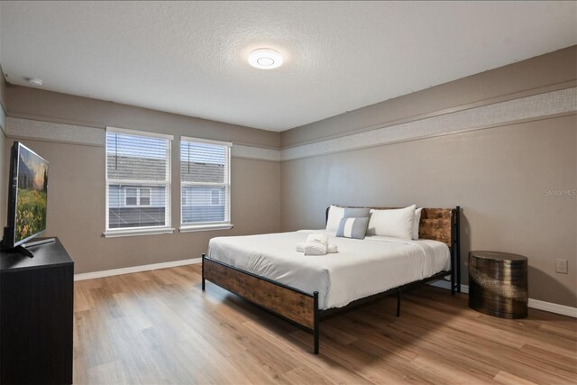 3806 Lana Ave, Davenport, FL 33897 - bedroom with light wood-type flooring and a textured ceiling