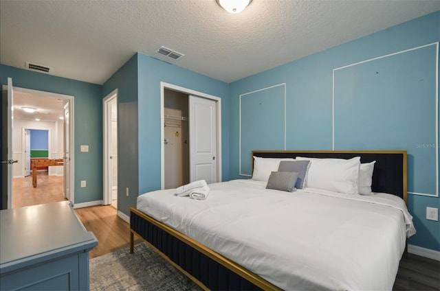 3806 Lana Ave, Davenport, FL 33897 - bedroom with wood finished floors, a textured ceiling, and a closet