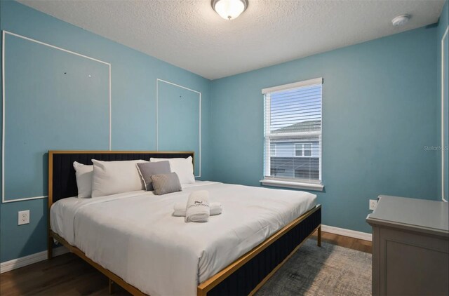 3806 Lana Ave, Davenport, FL 33897 - bedroom featuring dark wood finished floors and a textured ceiling