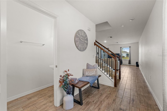 stairway featuring baseboards and wood finished floors