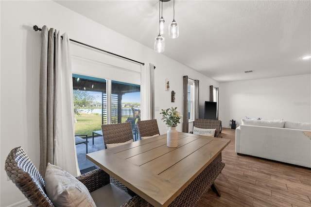 dining room with visible vents and wood finished floors