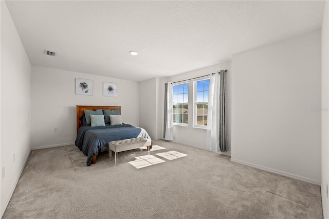 carpeted bedroom with baseboards and visible vents