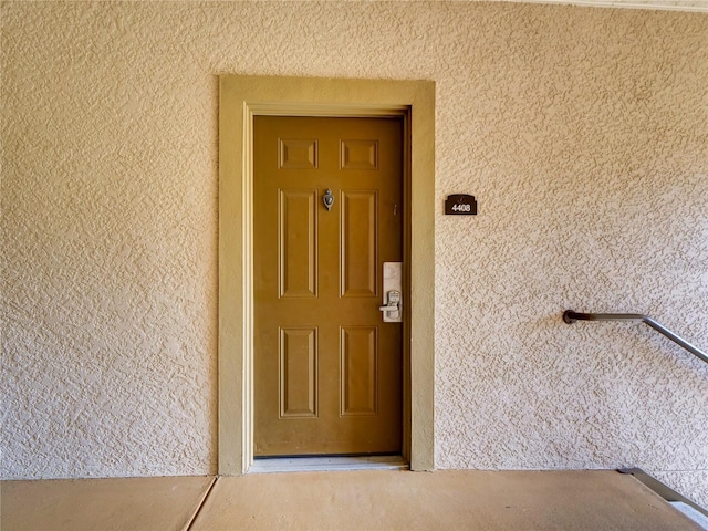 view of exterior entry featuring stucco siding
