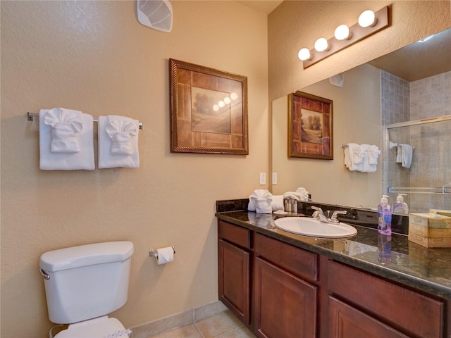 full bathroom with toilet, a shower stall, tile patterned flooring, and vanity