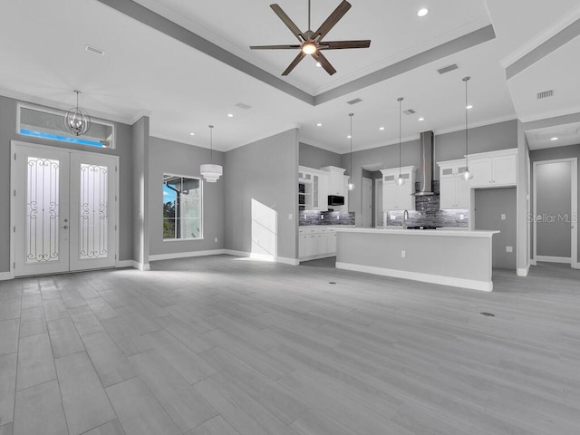 unfurnished living room featuring visible vents, baseboards, recessed lighting, and ornamental molding