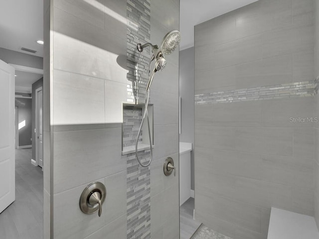 bathroom featuring visible vents and a walk in shower