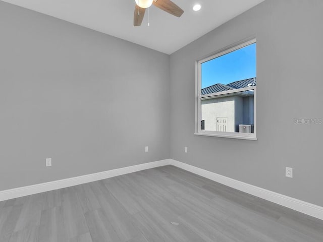 empty room featuring baseboards, a ceiling fan, wood finished floors, and recessed lighting