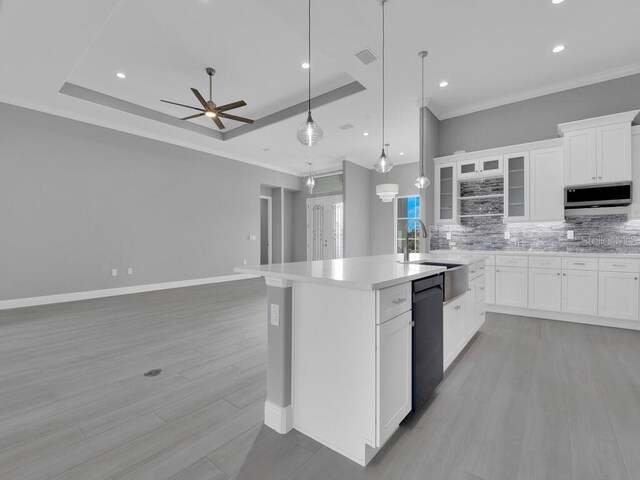 193 Rotonda Blvd S, Rotonda West, FL 33947 - kitchen featuring tasteful backsplash, a ceiling fan, an island with sink, stainless steel microwave, and black dishwasher