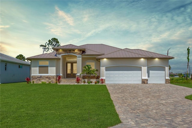 235 Rotonda Blvd S, Rotonda West, FL 33947 - view of front of house with a standing seam roof, french doors, stone siding, and decorative driveway