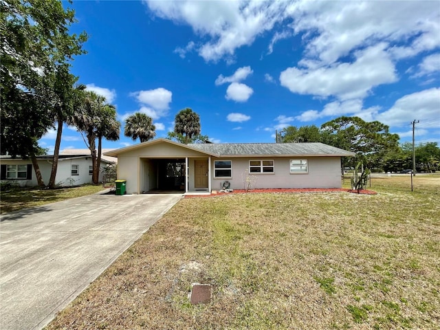 ranch-style house featuring concrete driveway and a front lawn