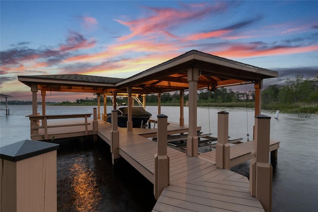 dock area with a water view and boat lift