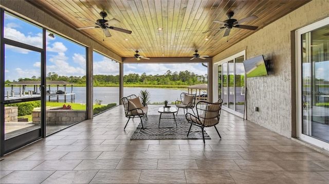 sunroom with wooden ceiling and ceiling fan