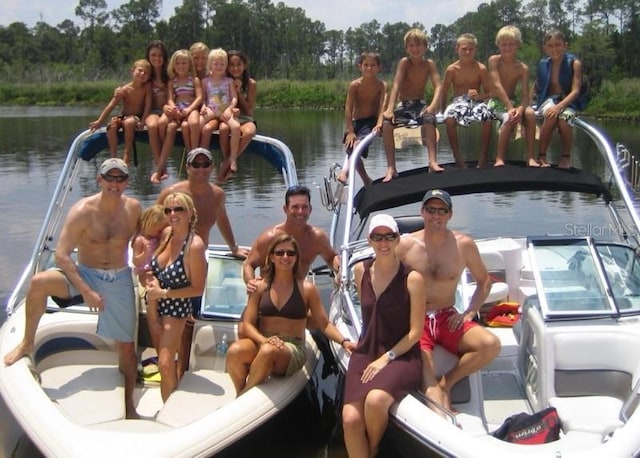 surrounding community featuring a dock and a water view