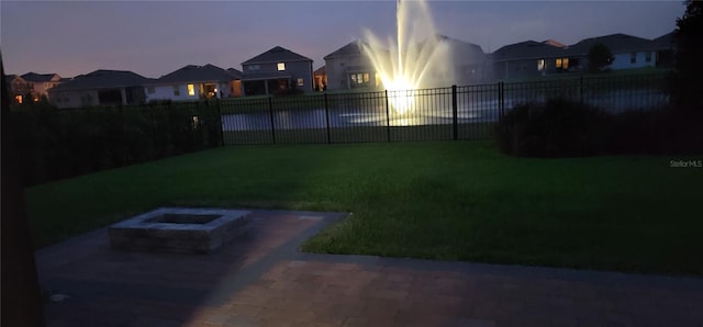 16124 Azure Key St, Winter Garden, FL 34787 - yard at dusk with a patio area, a fire pit, and a residential view