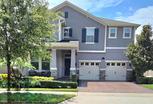 16124 Azure Key St, Winter Garden, FL 34787 - craftsman-style home with a garage, decorative driveway, and stone siding
