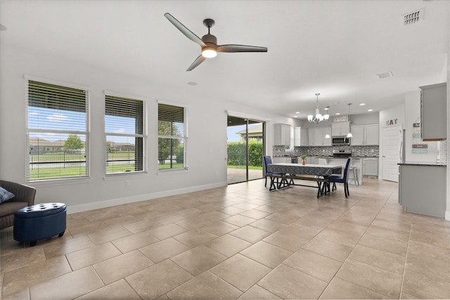 16124 Azure Key St, Winter Garden, FL 34787 - living room with a chandelier, a ceiling fan, baseboards, light tile patterned floors, and recessed lighting