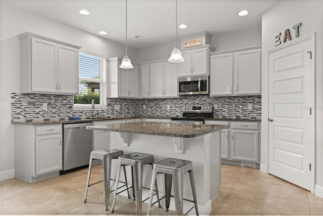 16124 Azure Key St, Winter Garden, FL 34787 - kitchen featuring stainless steel appliances, a breakfast bar, a kitchen island, decorative backsplash, and recessed lighting