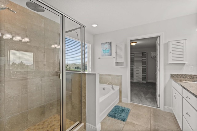 16124 Azure Key St, Winter Garden, FL 34787 - bathroom with a stall shower, a garden tub, vanity, tile patterned flooring, and a spacious closet