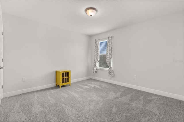 16124 Azure Key St, Winter Garden, FL 34787 - carpeted empty room with baseboards and a textured ceiling