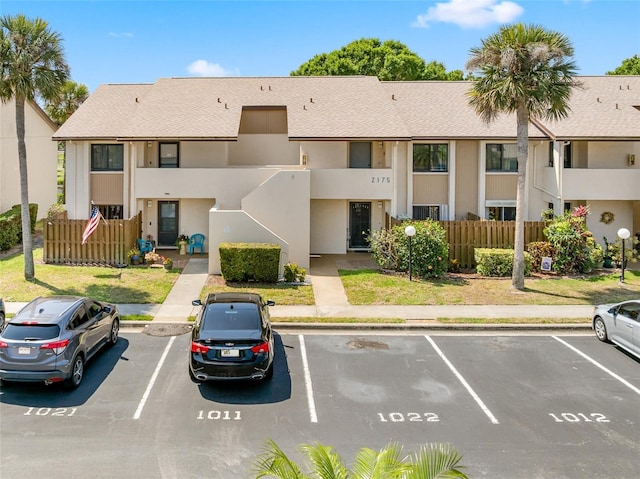 2175 Golf Isle Dr Unit 1022, Melbourne, FL 32935 - view of building exterior featuring fence and uncovered parking