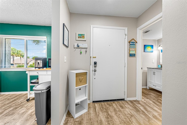 2175 Golf Isle Dr Unit 1022, Melbourne, FL 32935 - entryway with baseboards, wood finished floors, and visible vents