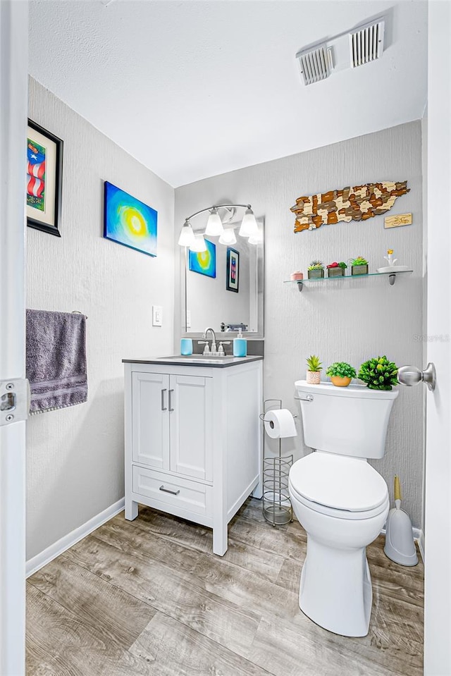 2175 Golf Isle Dr Unit 1022, Melbourne, FL 32935 - half bath with toilet, visible vents, wood finished floors, and vanity