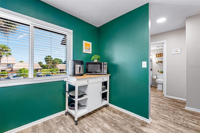 2175 Golf Isle Dr Unit 1022, Melbourne, FL 32935 - home office featuring baseboards, a textured ceiling, and wood finished floors