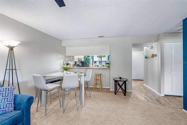 2175 Golf Isle Dr Unit 1022, Melbourne, FL 32935 - carpeted dining room featuring baseboards, a textured ceiling, and visible vents