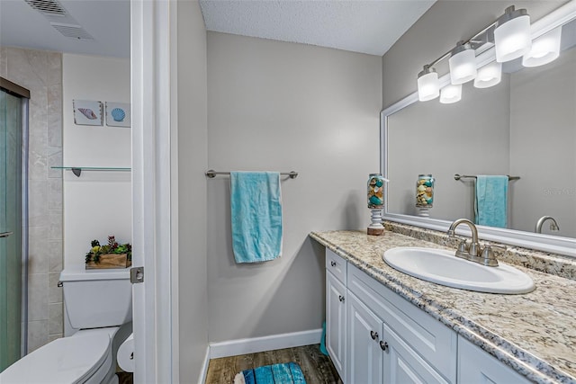 2175 Golf Isle Dr Unit 1022, Melbourne, FL 32935 - bathroom with visible vents, wood finished floors, vanity, baseboards, and toilet