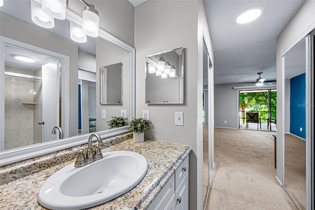 2175 Golf Isle Dr Unit 1022, Melbourne, FL 32935 - bathroom featuring vanity, ceiling fan, and a tile shower