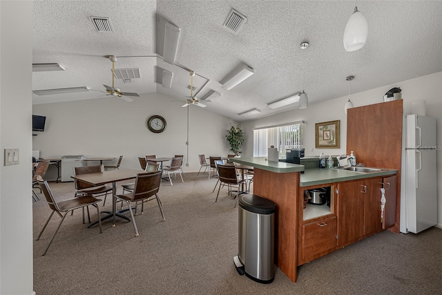 2175 Golf Isle Dr Unit 1022, Melbourne, FL 32935 - kitchen with visible vents, freestanding refrigerator, a textured ceiling, and ceiling fan