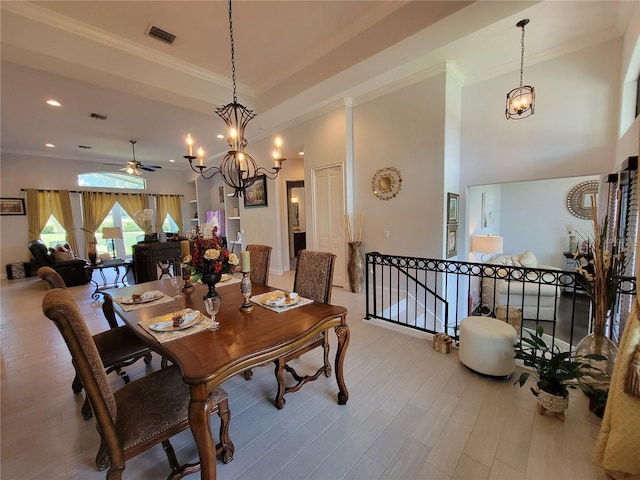 603 Sanctuary Golf Pl, Apopka, FL 32712 - dining room featuring ceiling fan with notable chandelier, wood finished floors, visible vents, and ornamental molding