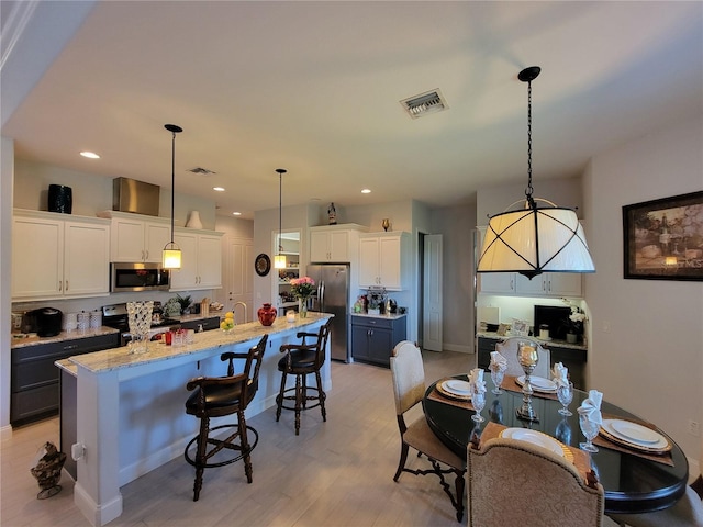 603 Sanctuary Golf Pl, Apopka, FL 32712 - dining space featuring visible vents, light wood finished floors, and recessed lighting