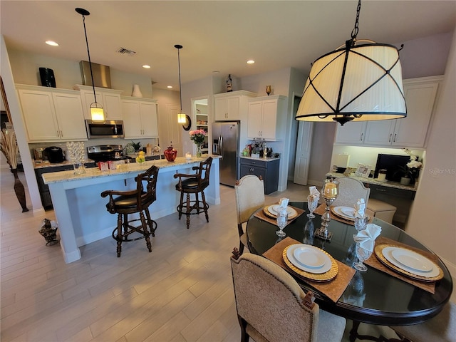 603 Sanctuary Golf Pl, Apopka, FL 32712 - dining area with light wood finished floors, visible vents, and recessed lighting