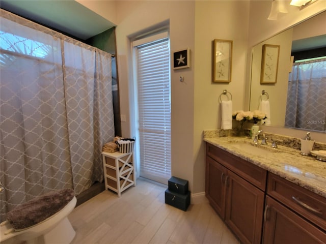 603 Sanctuary Golf Pl, Apopka, FL 32712 - full bath with baseboards, vanity, wood finished floors, and plenty of natural light