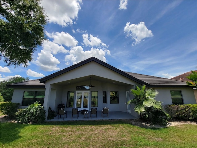 603 Sanctuary Golf Pl, Apopka, FL 32712 - back of house featuring a tiled roof, a yard, stucco siding, ceiling fan, and a patio