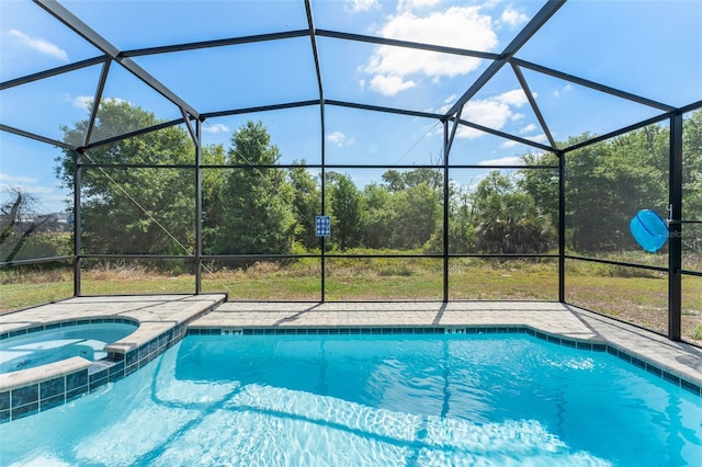view of pool featuring glass enclosure and a pool with connected hot tub