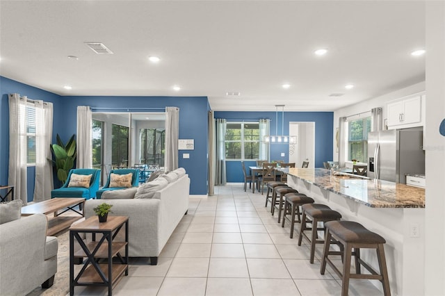 living area with visible vents, recessed lighting, baseboards, and light tile patterned flooring