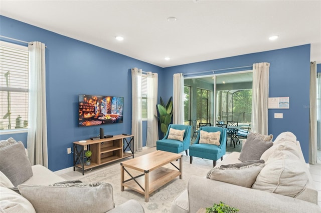 living area featuring baseboards and recessed lighting