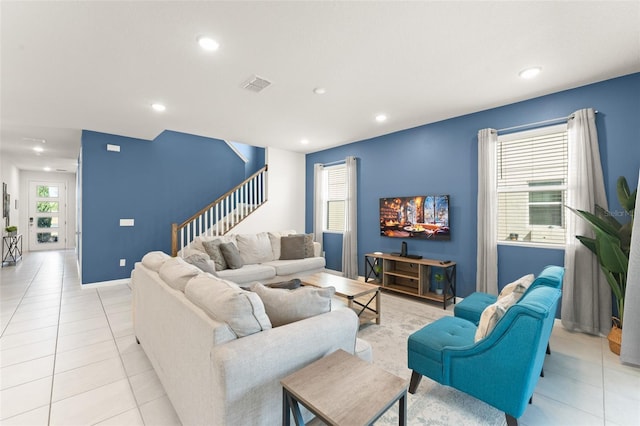 living room featuring visible vents, stairway, baseboards, recessed lighting, and light tile patterned flooring