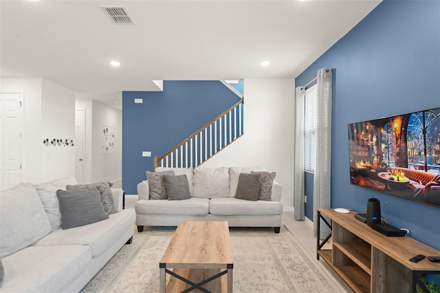 living room with recessed lighting, baseboards, visible vents, and stairway