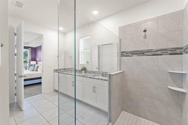 ensuite bathroom featuring walk in shower, tile patterned flooring, ensuite bath, double vanity, and visible vents