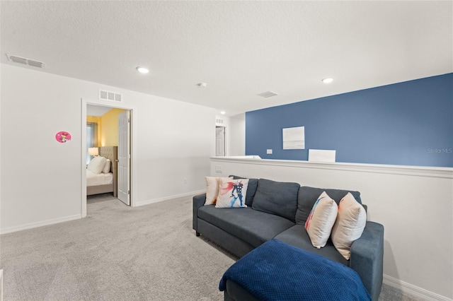 living area with carpet floors, recessed lighting, baseboards, and visible vents