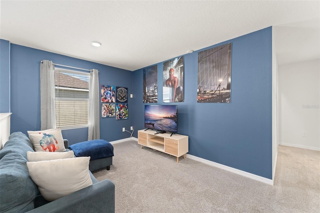 carpeted living room with a textured ceiling and baseboards